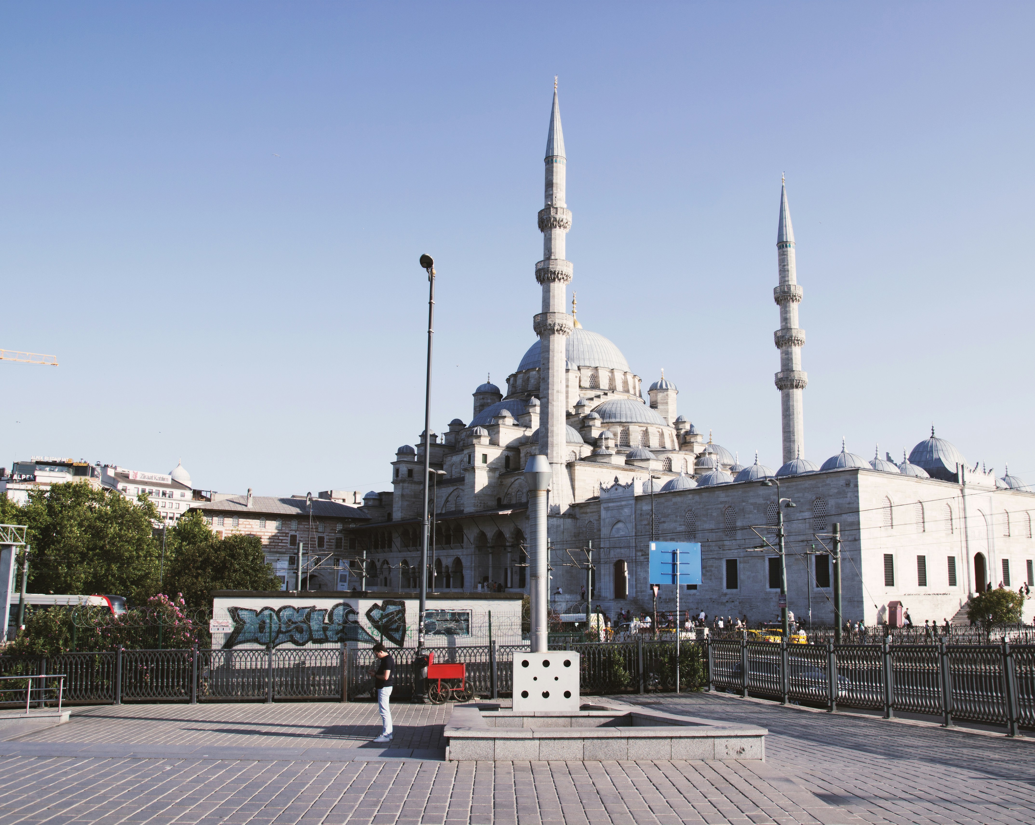 A person standing in front of a large building