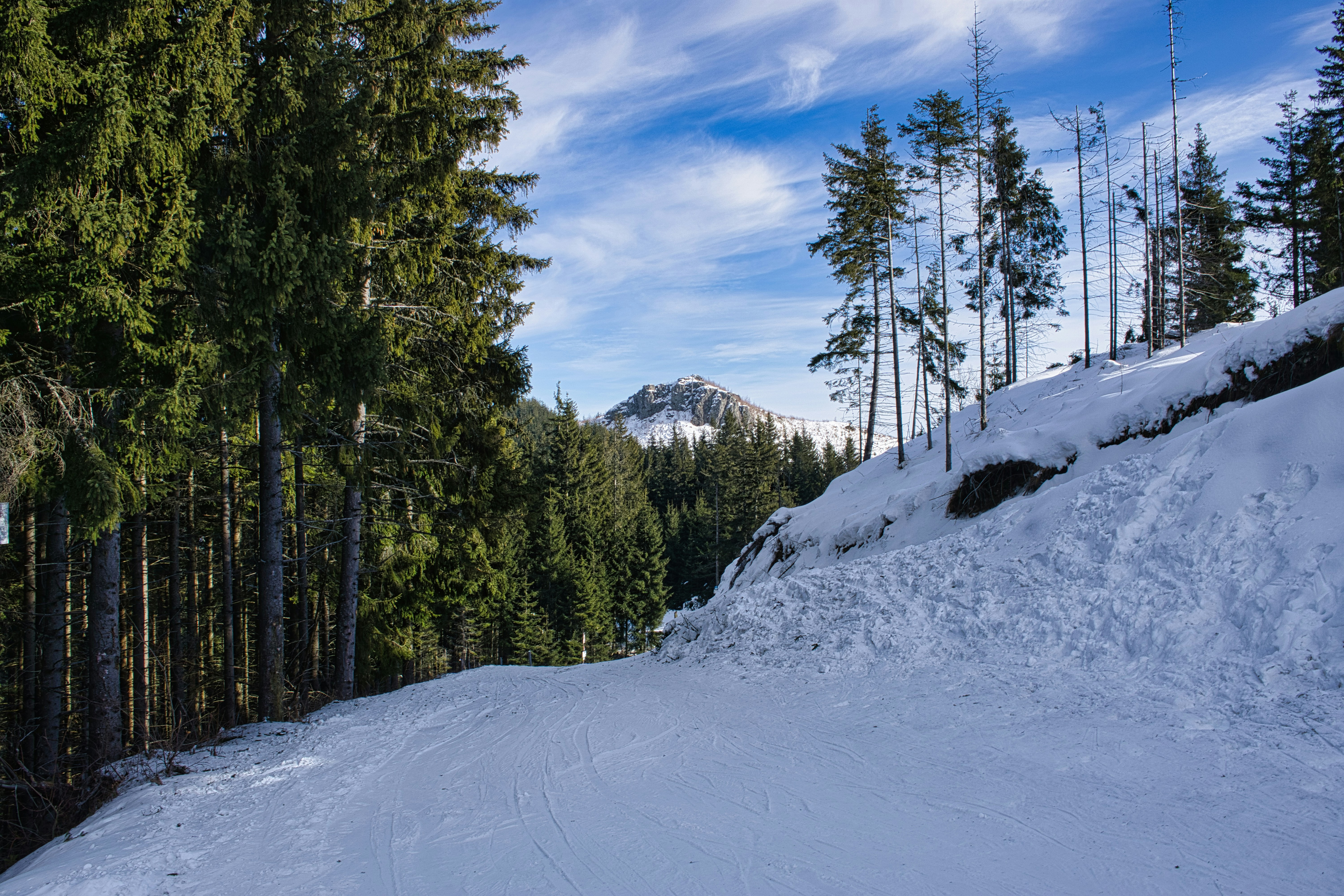 A man riding a snowboard down a snow covered slope