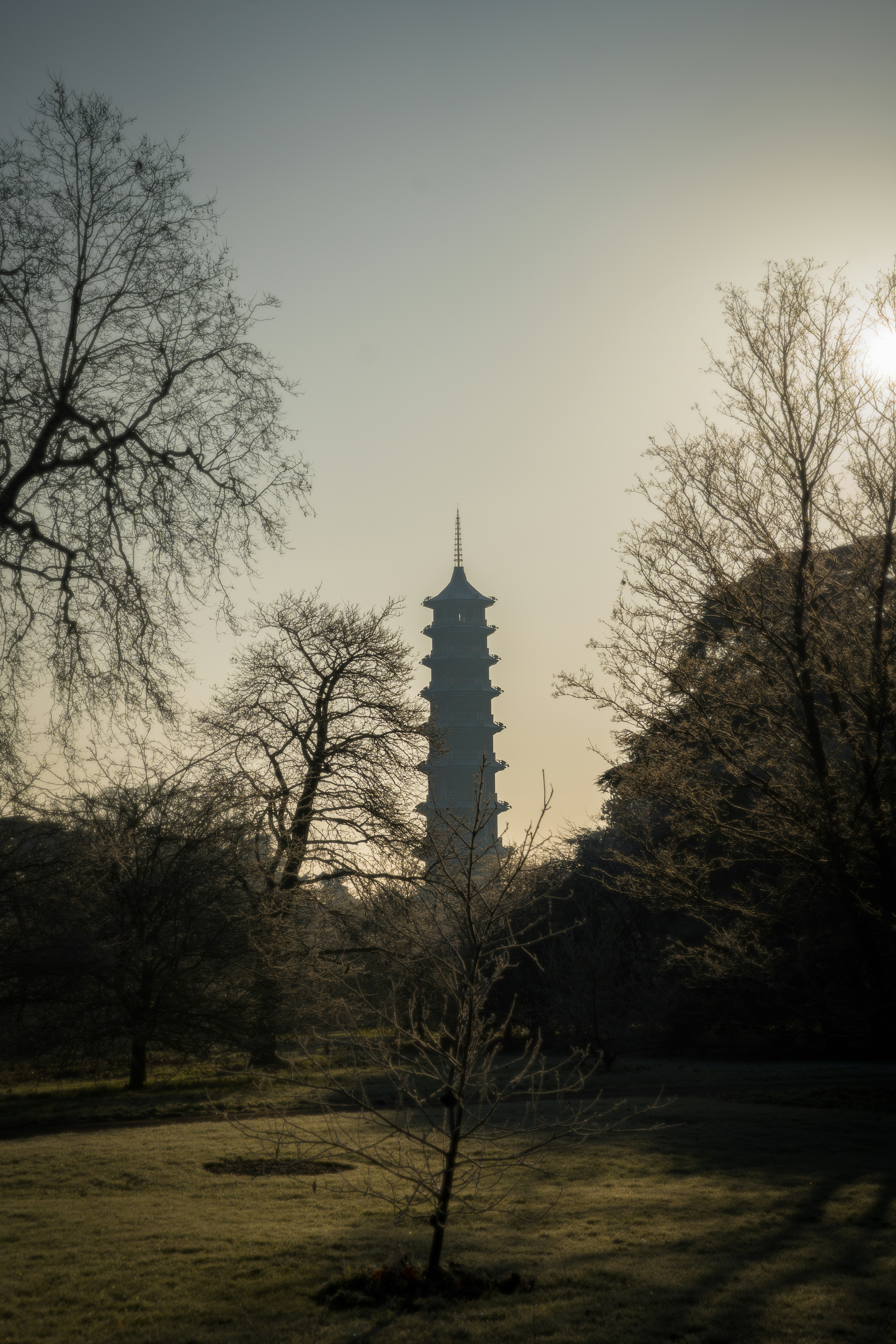 A tall tower towering over a lush green field
