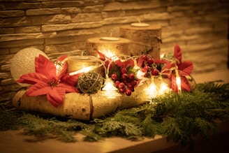 A candle and some christmas decorations on a table