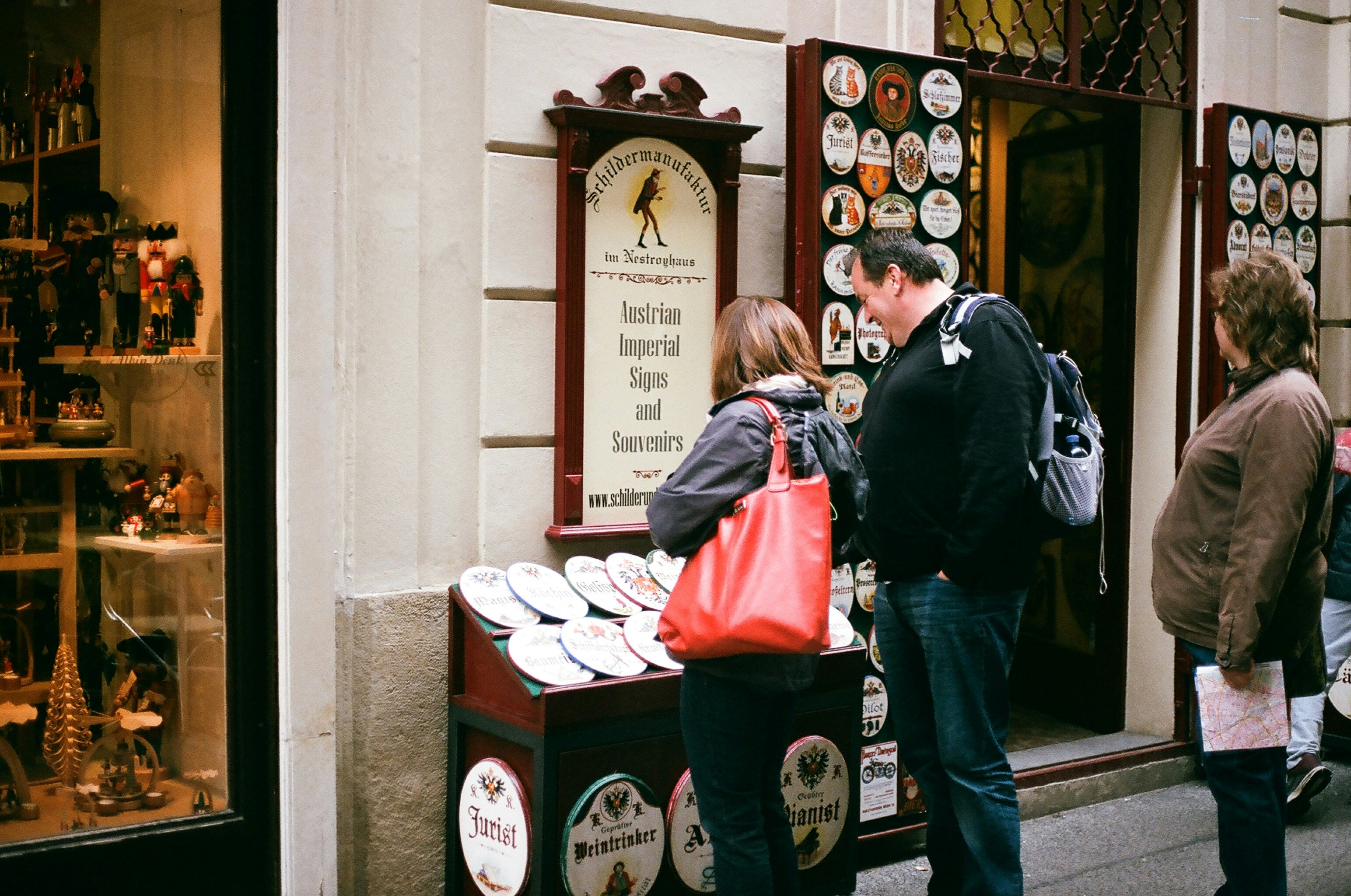 A group of people standing outside of a store