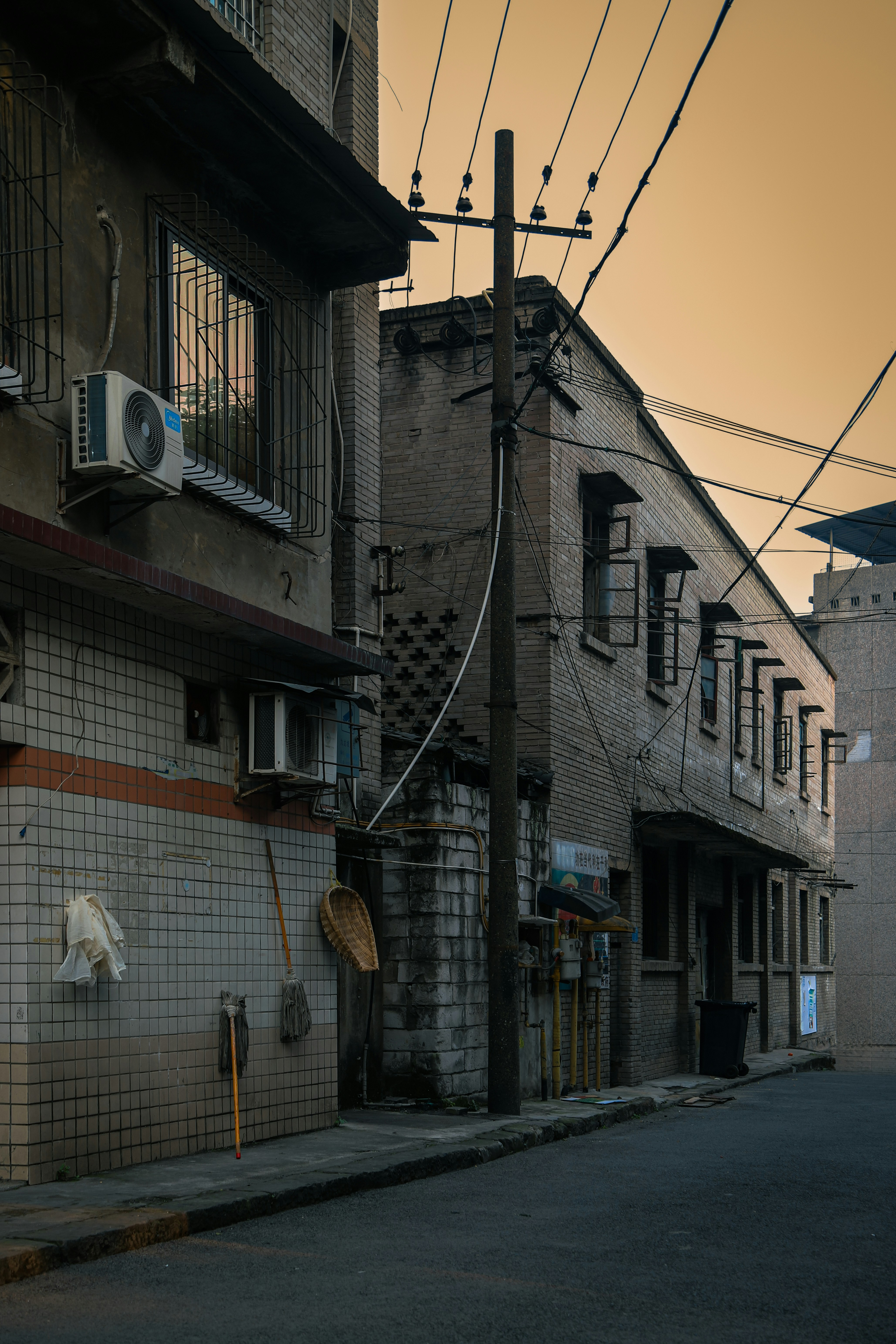 A street with a building and a clock on the side of it