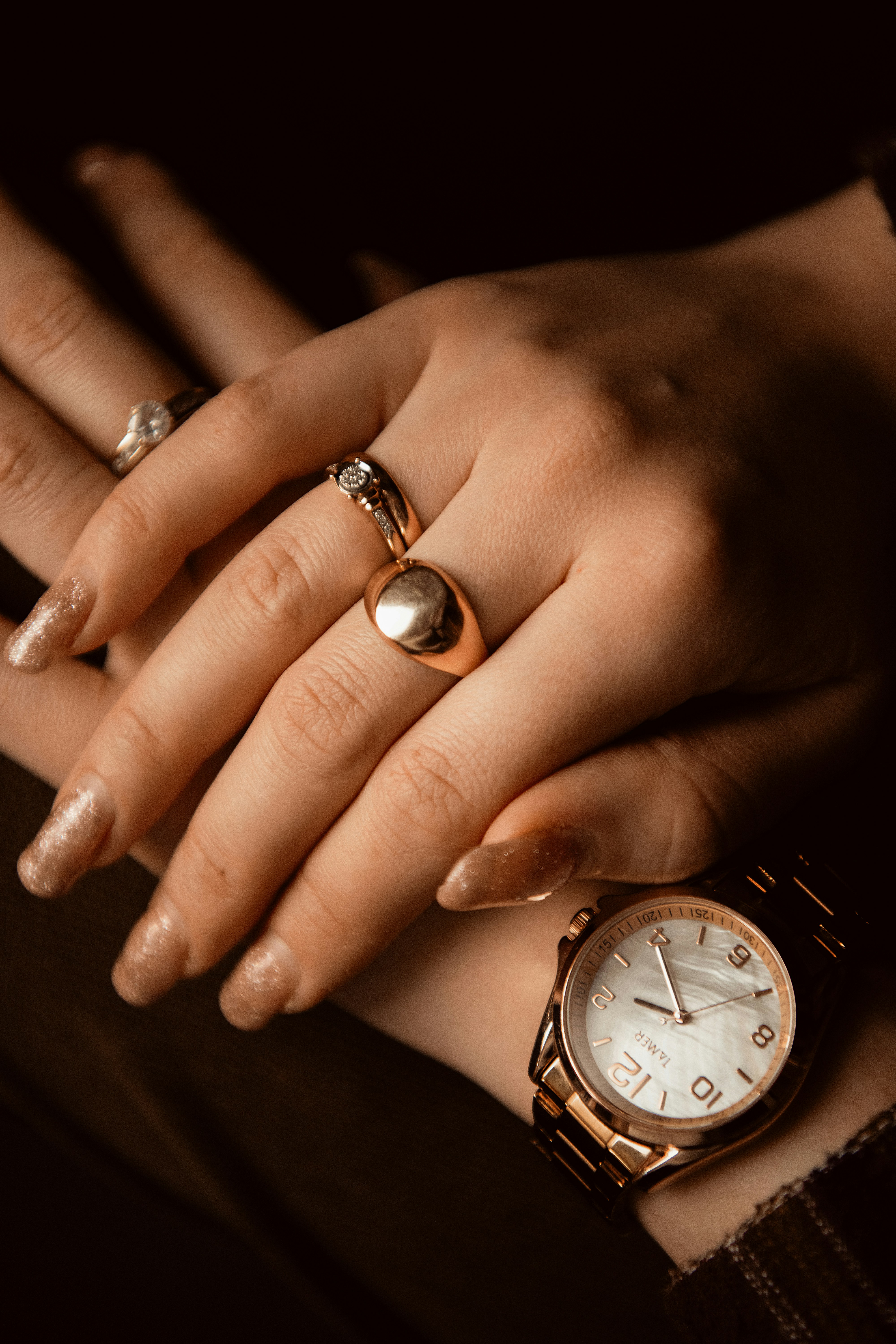 A woman's hands with rings and a watch