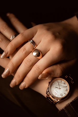 A woman's hands with rings and a watch