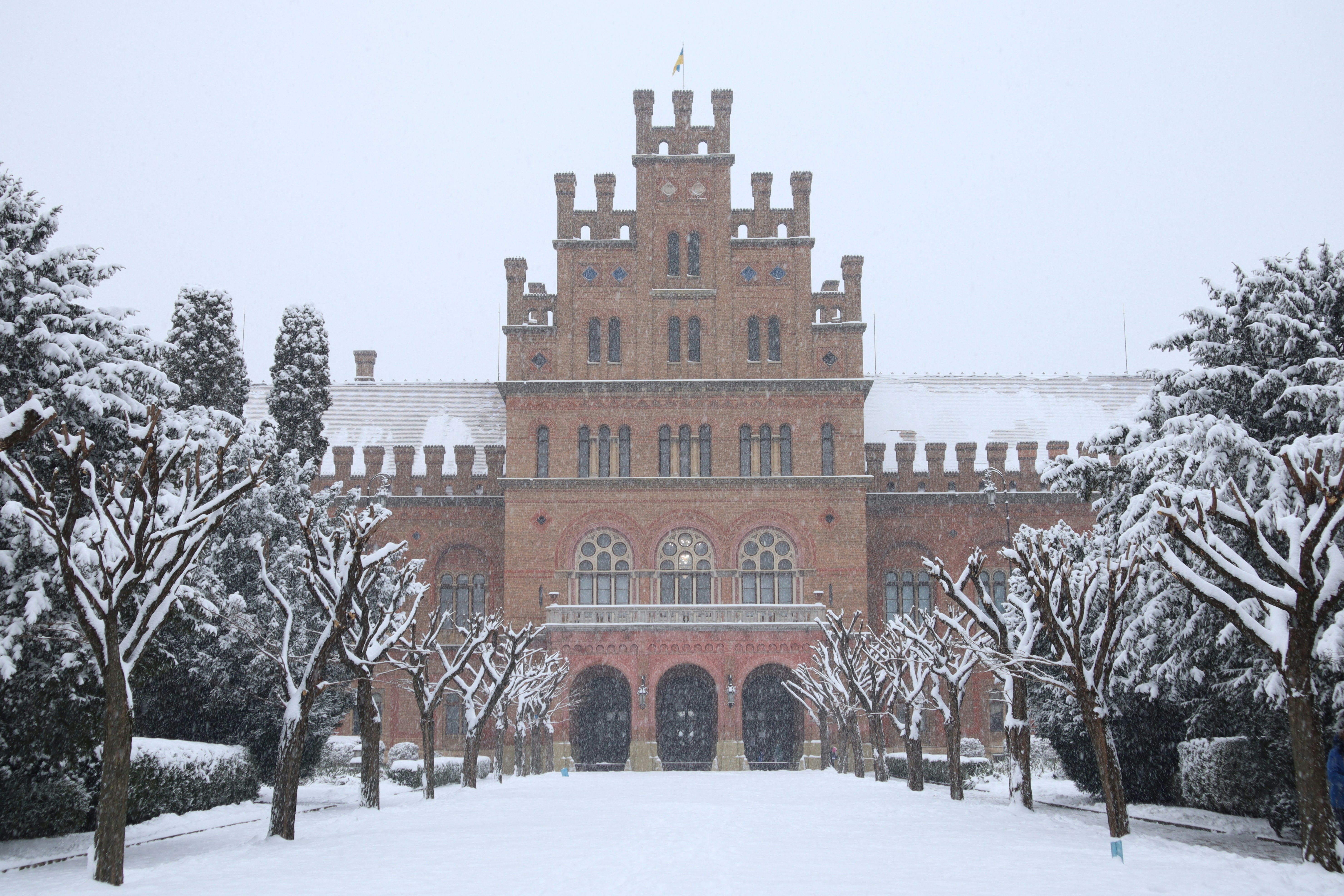 A large building with a lot of trees in front of it, 