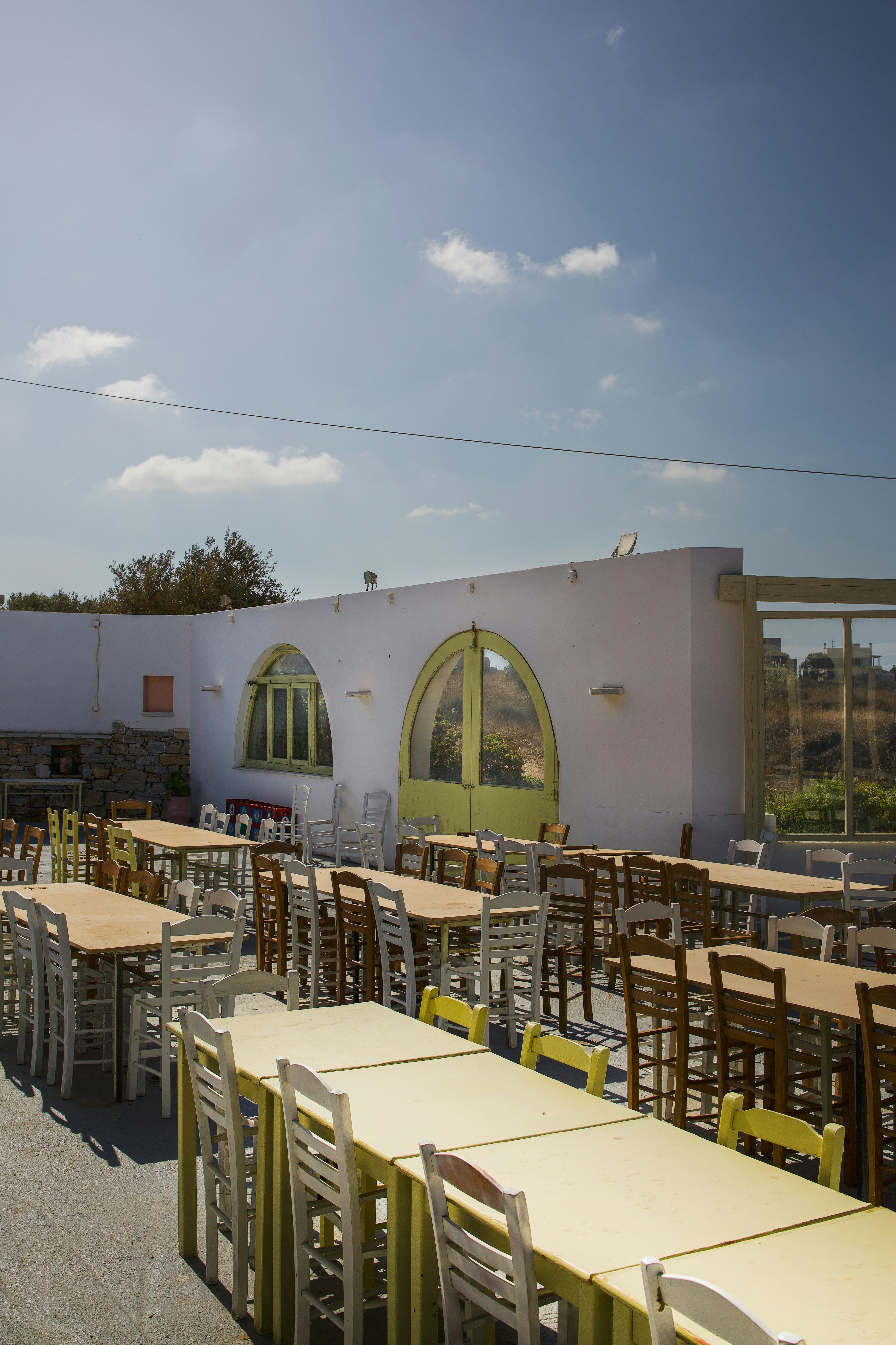 A row of tables and chairs outside of a building