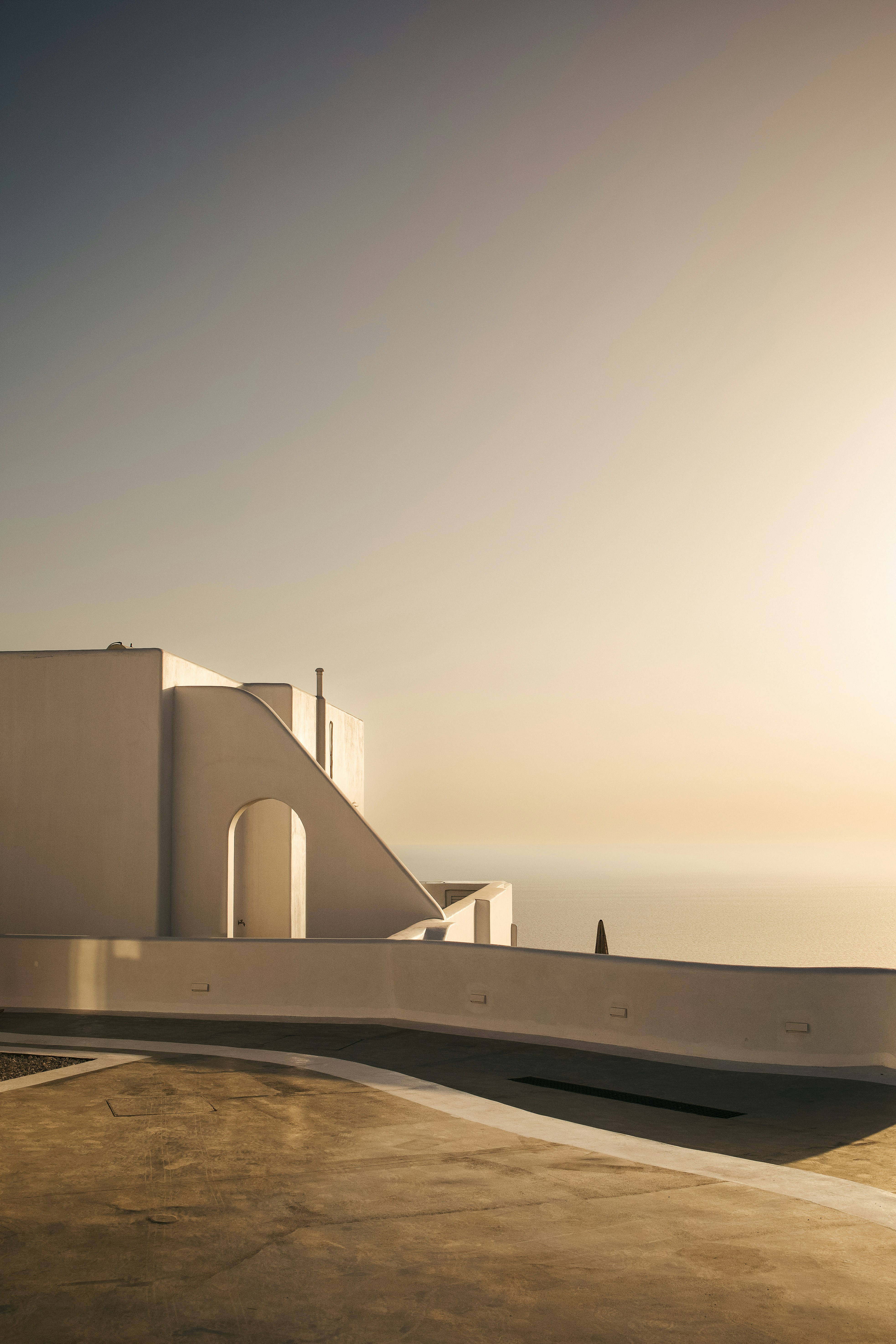 A white building with a clock on the top of it