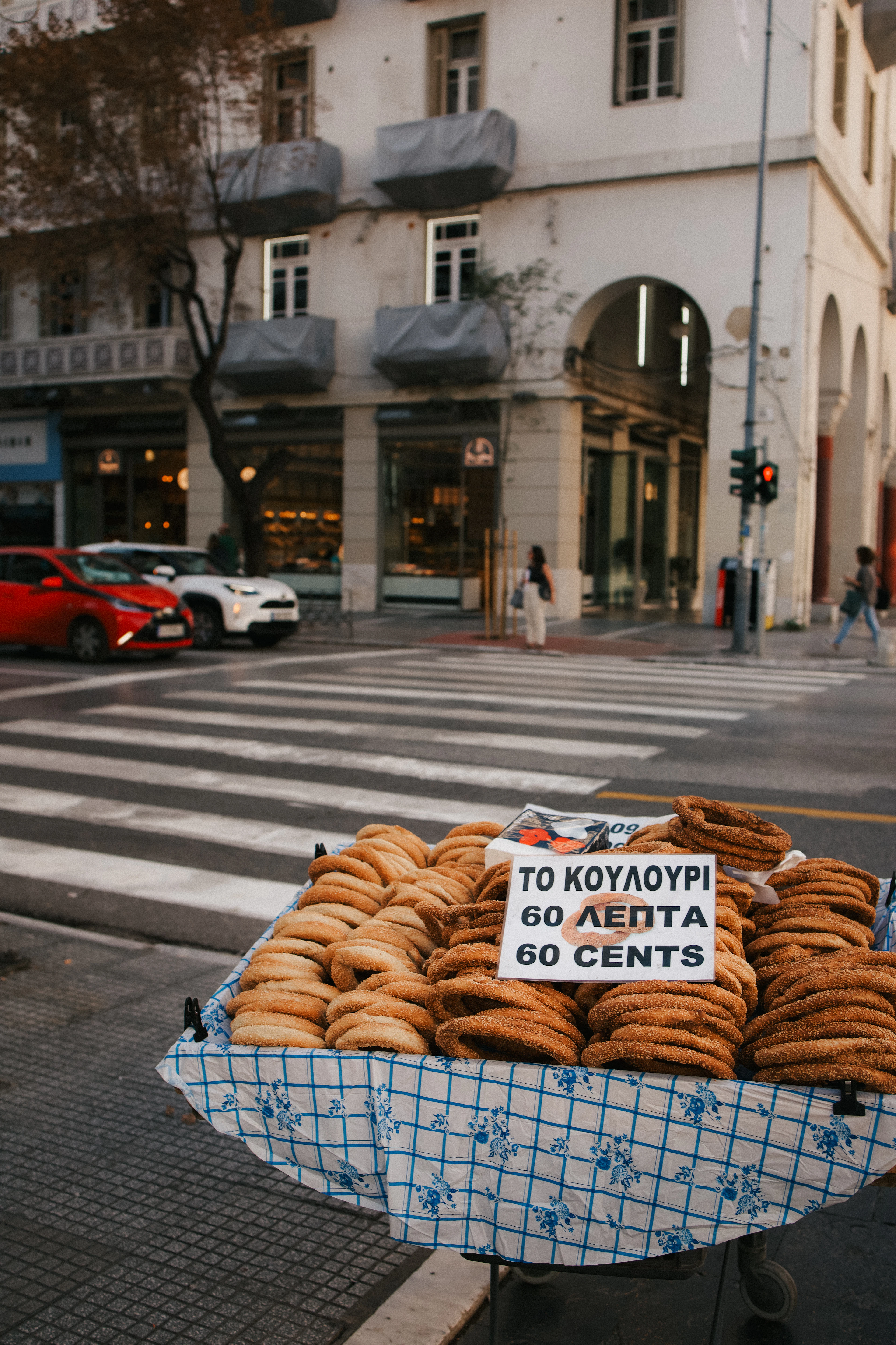 A koulouri seller's cart on a Thessaloniki street, the price chalked at sixty cents