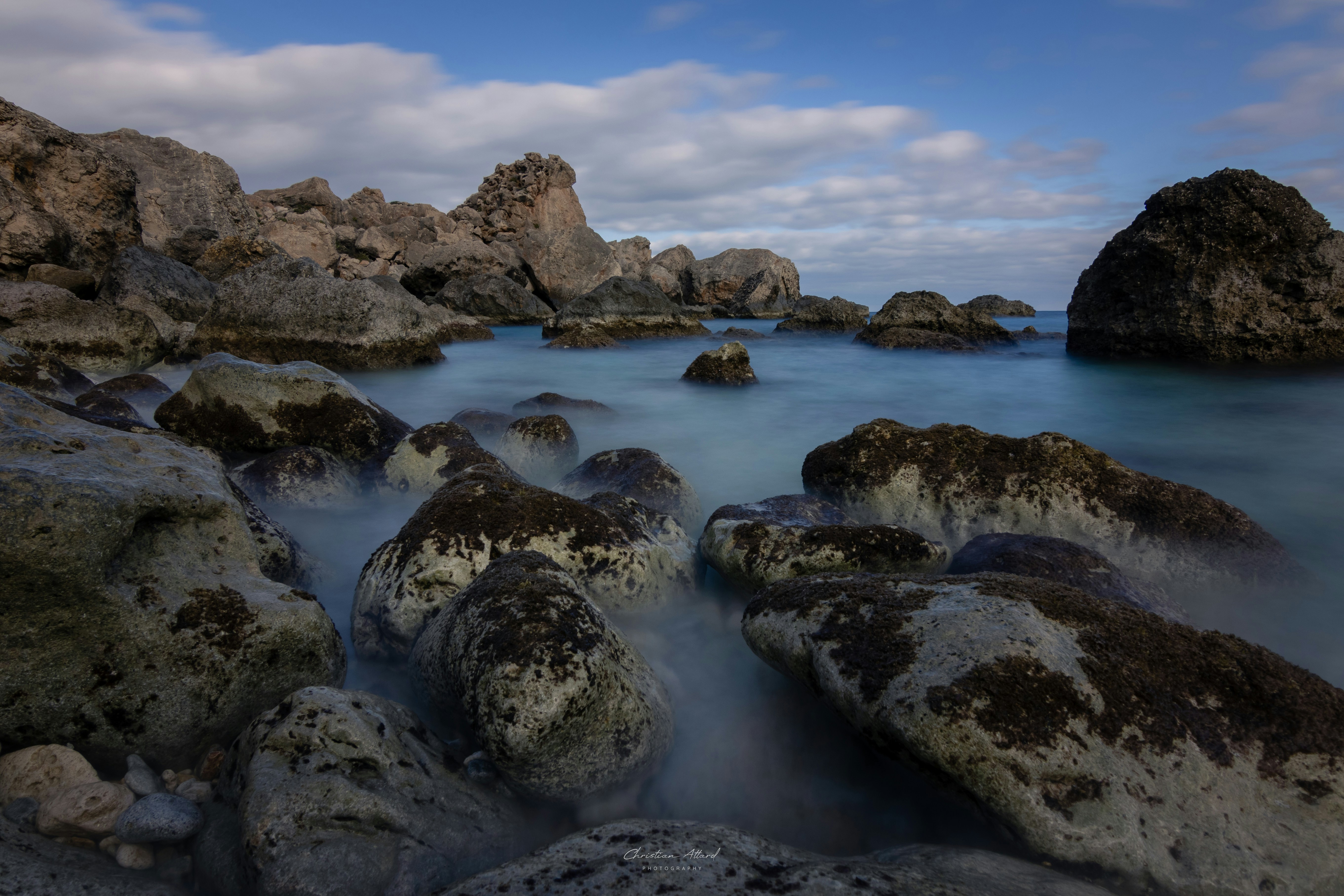 A bunch of rocks that are in the water