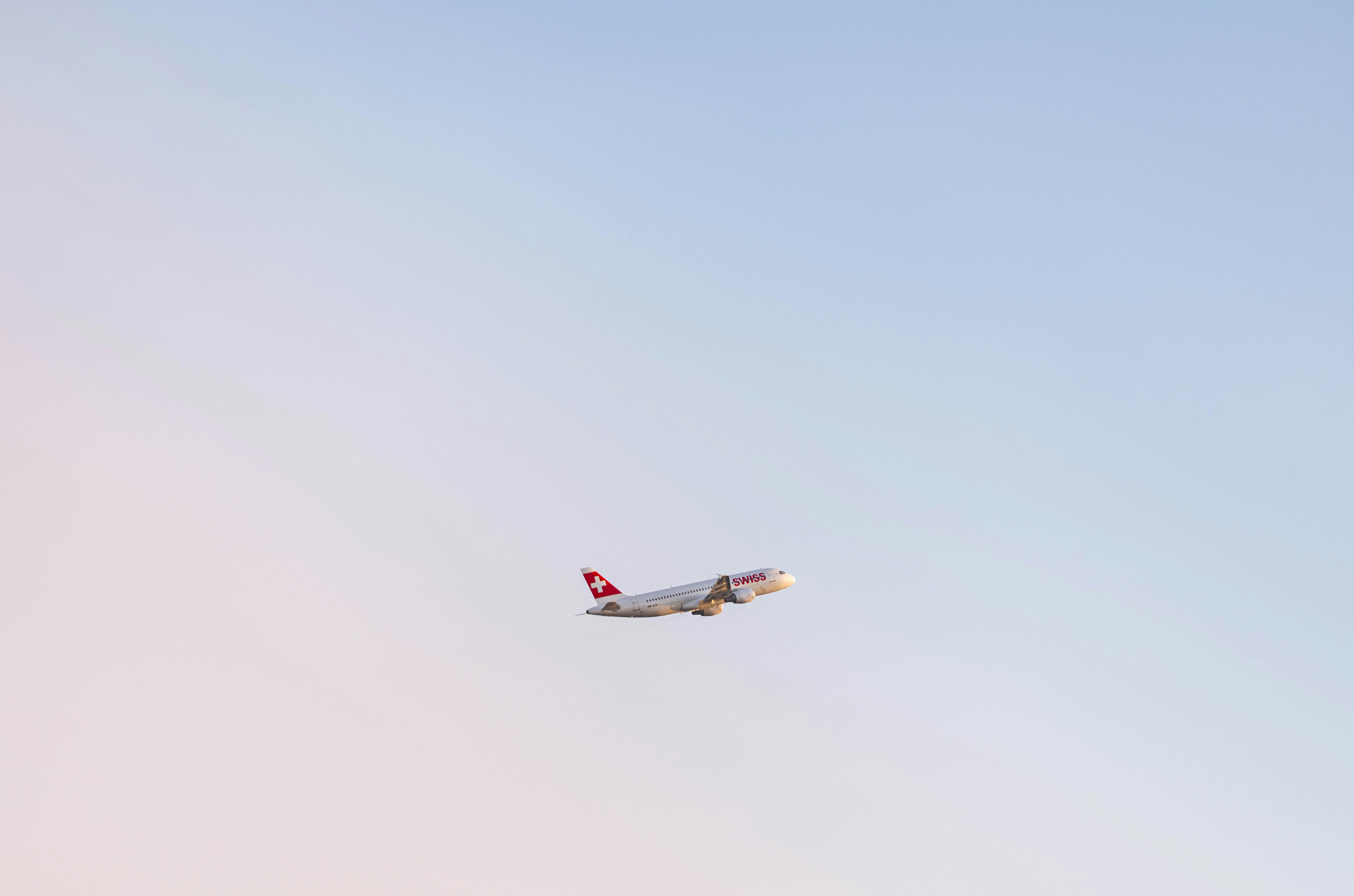 An airplane flying in the sky with a blue sky background