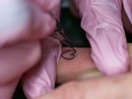 A woman getting a tattoo on her arm