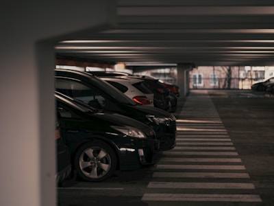 A parking garage filled with lots of parked cars