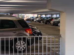 A parking garage filled with lots of parked cars