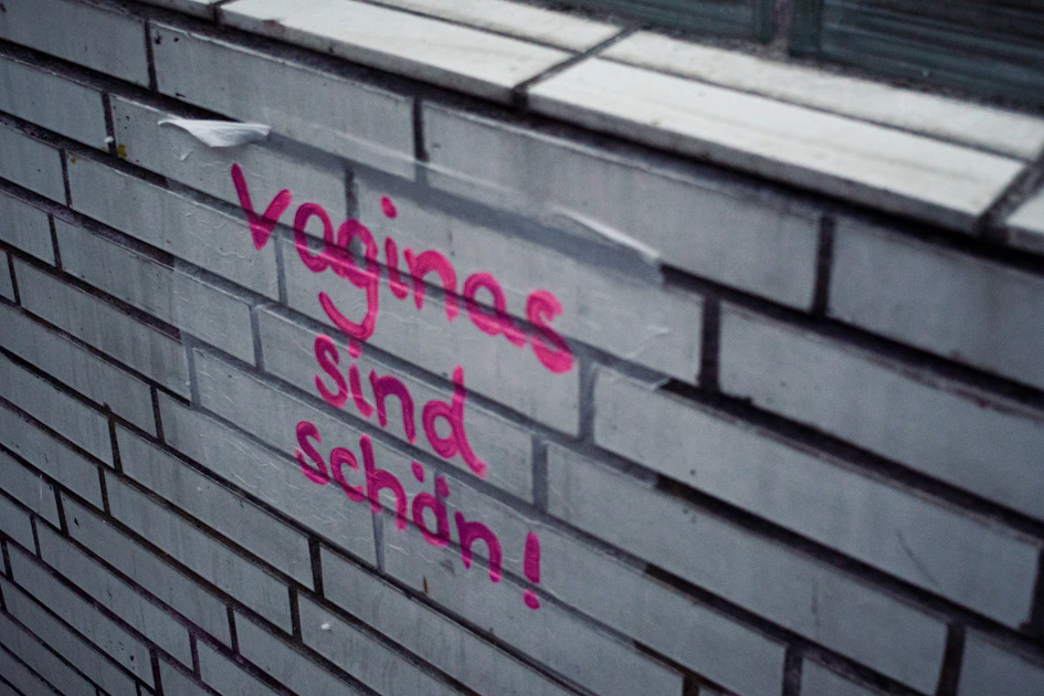 A brick wall with graffiti written on it