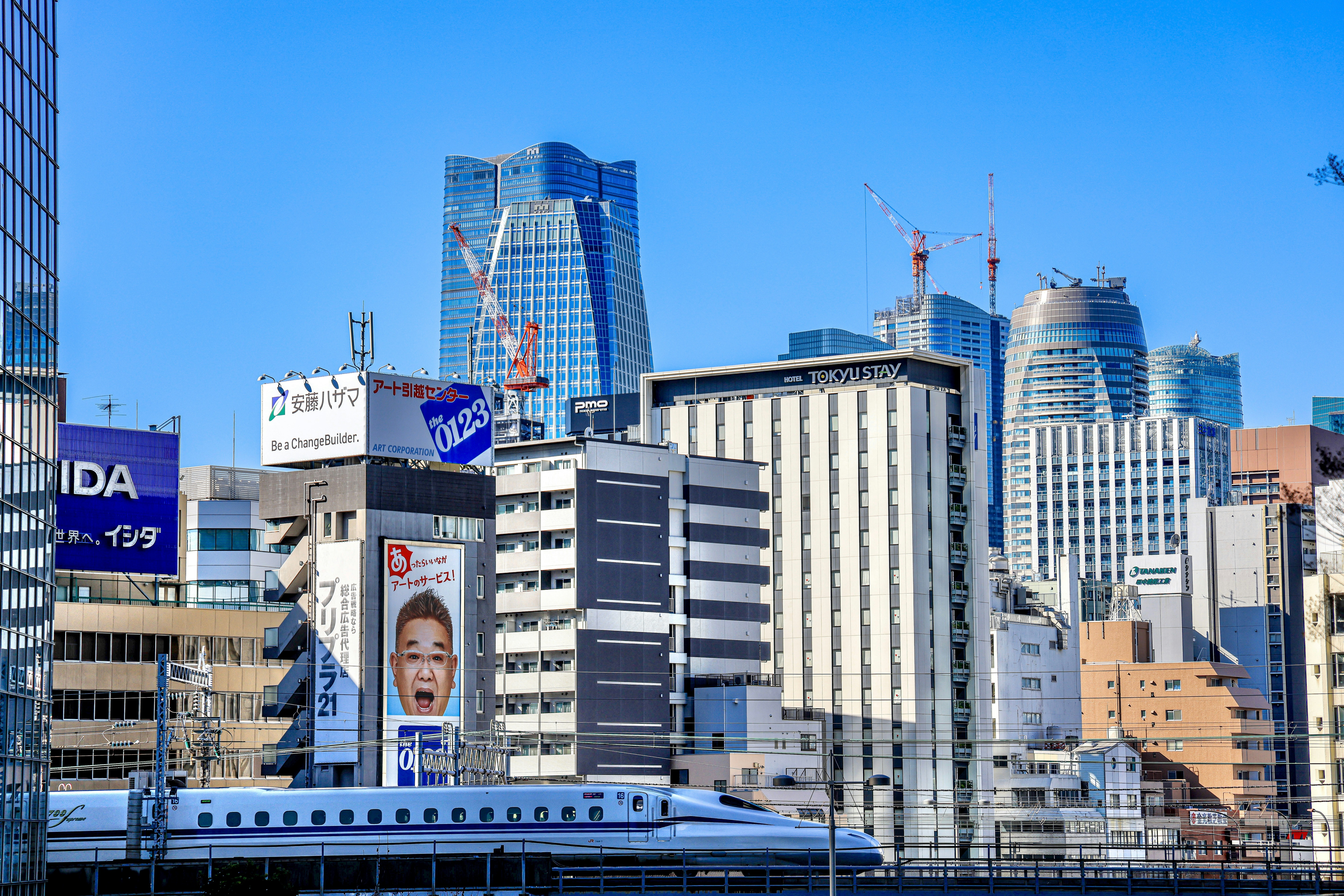 A city skyline with tall buildings and a train on the tracks photo ...
