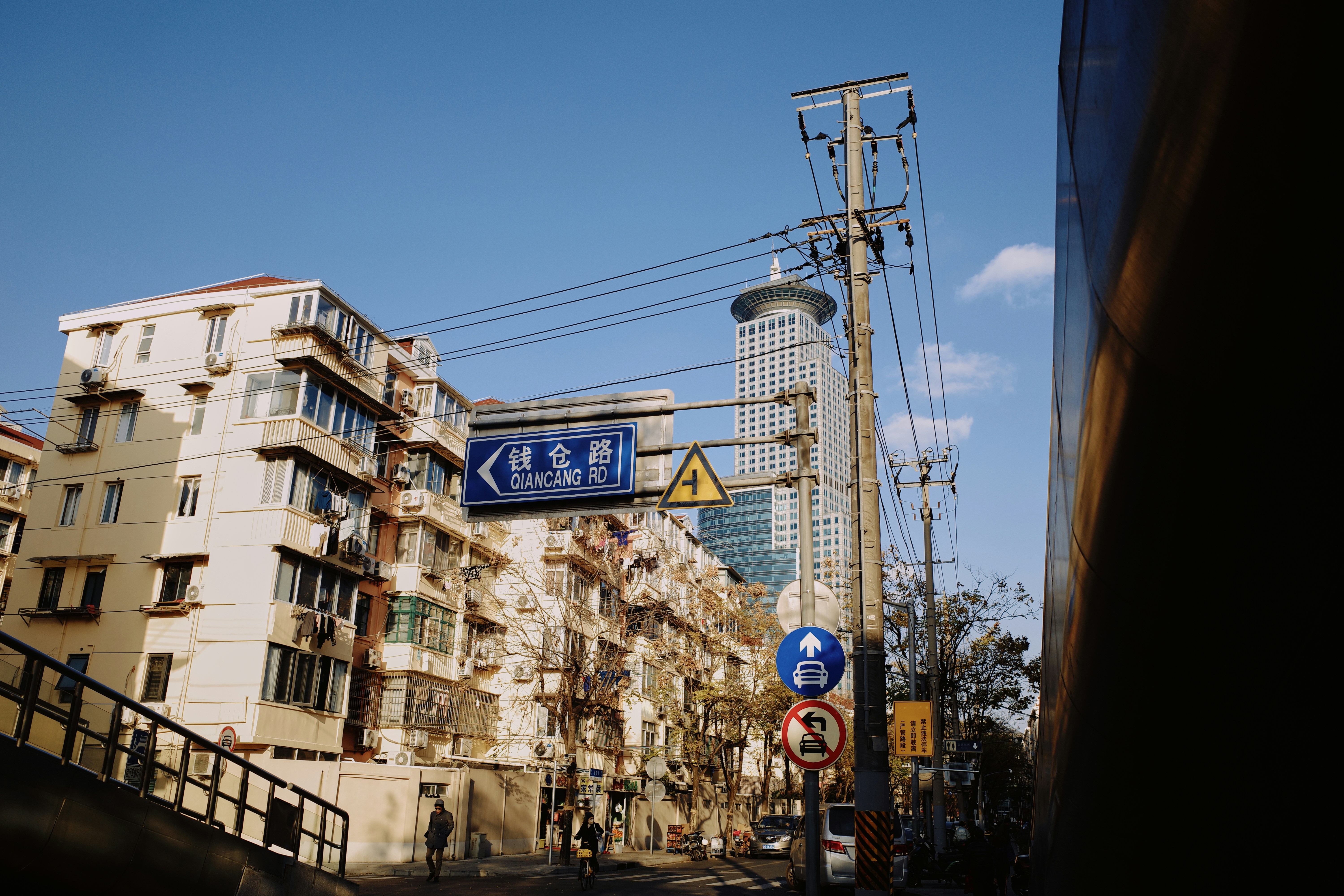 A city street with a tall building in the background