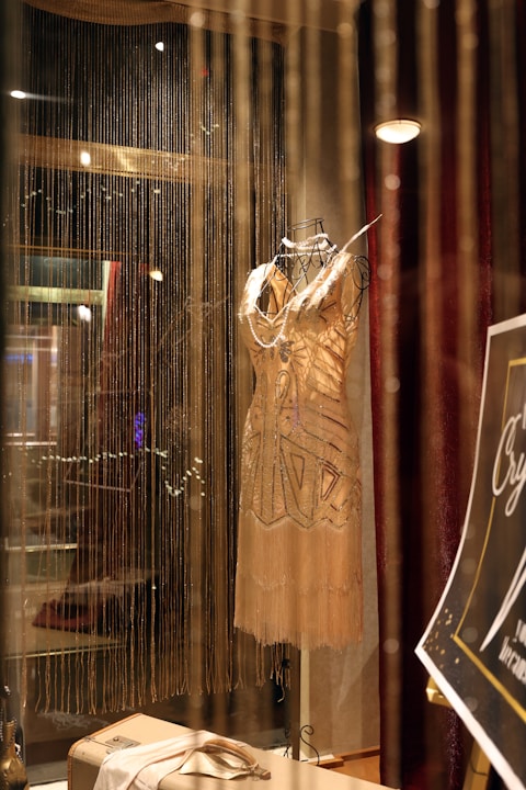 A display case with a dress on a mannequin
