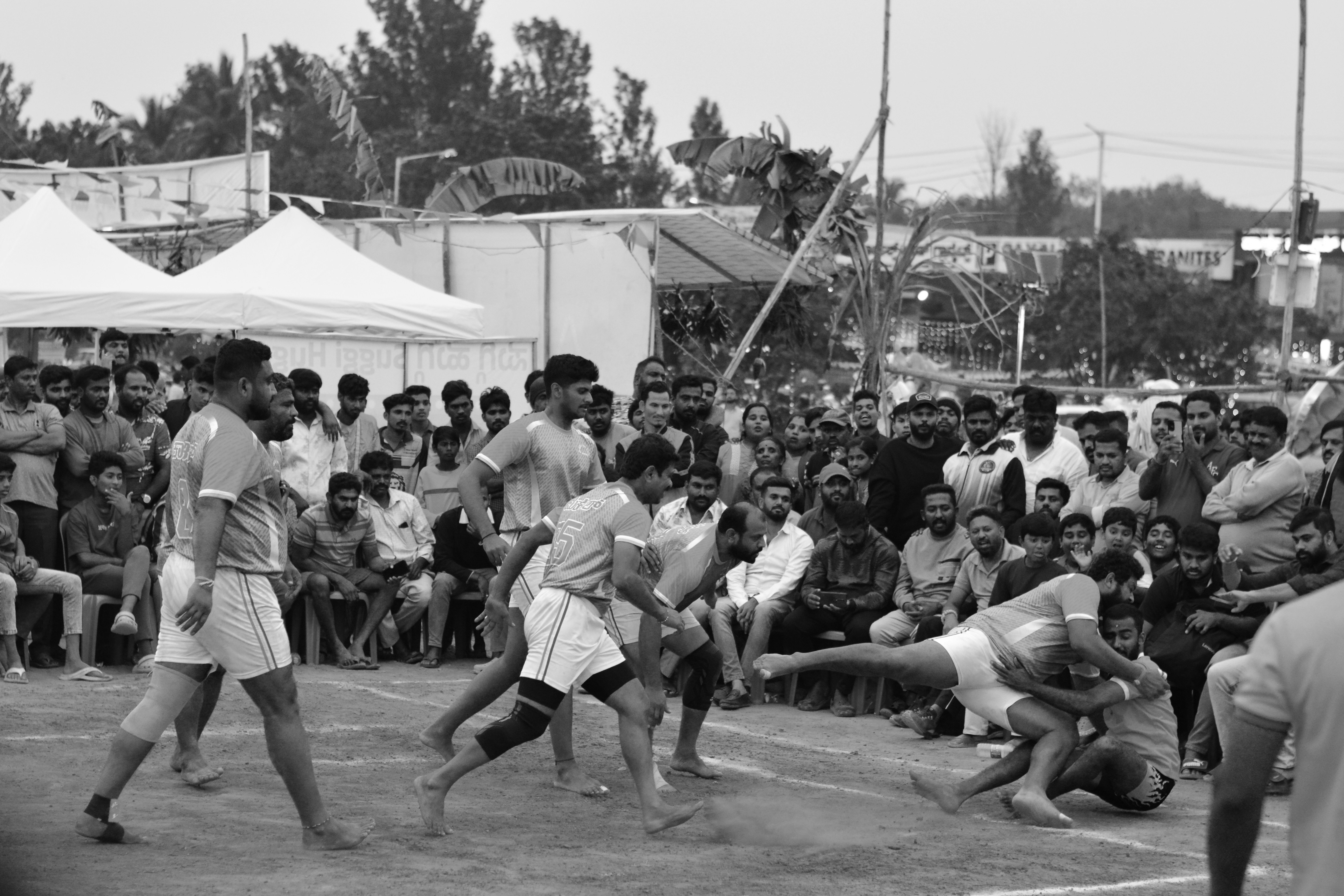 A group of men playing a game of tennis
