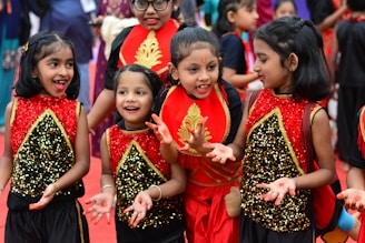 A group of young girls standing next to each other