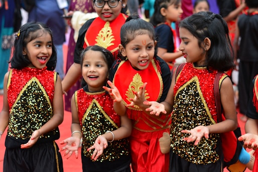 A group of young girls standing next to each other