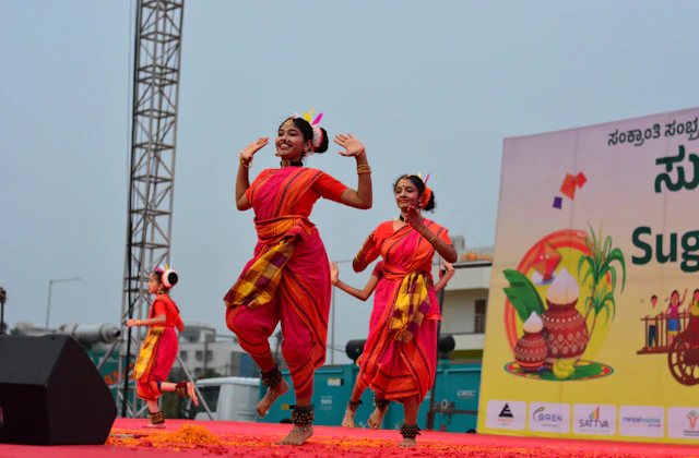 Students performing in a cultural event on stage at NewAge PU College