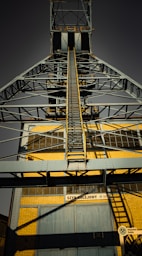A tall metal structure with a sky background