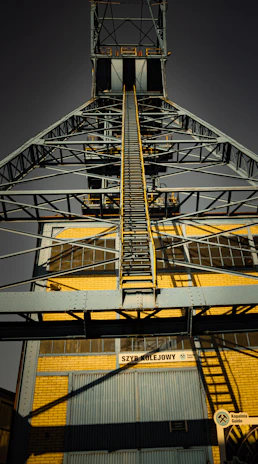 A tall metal structure with a sky background