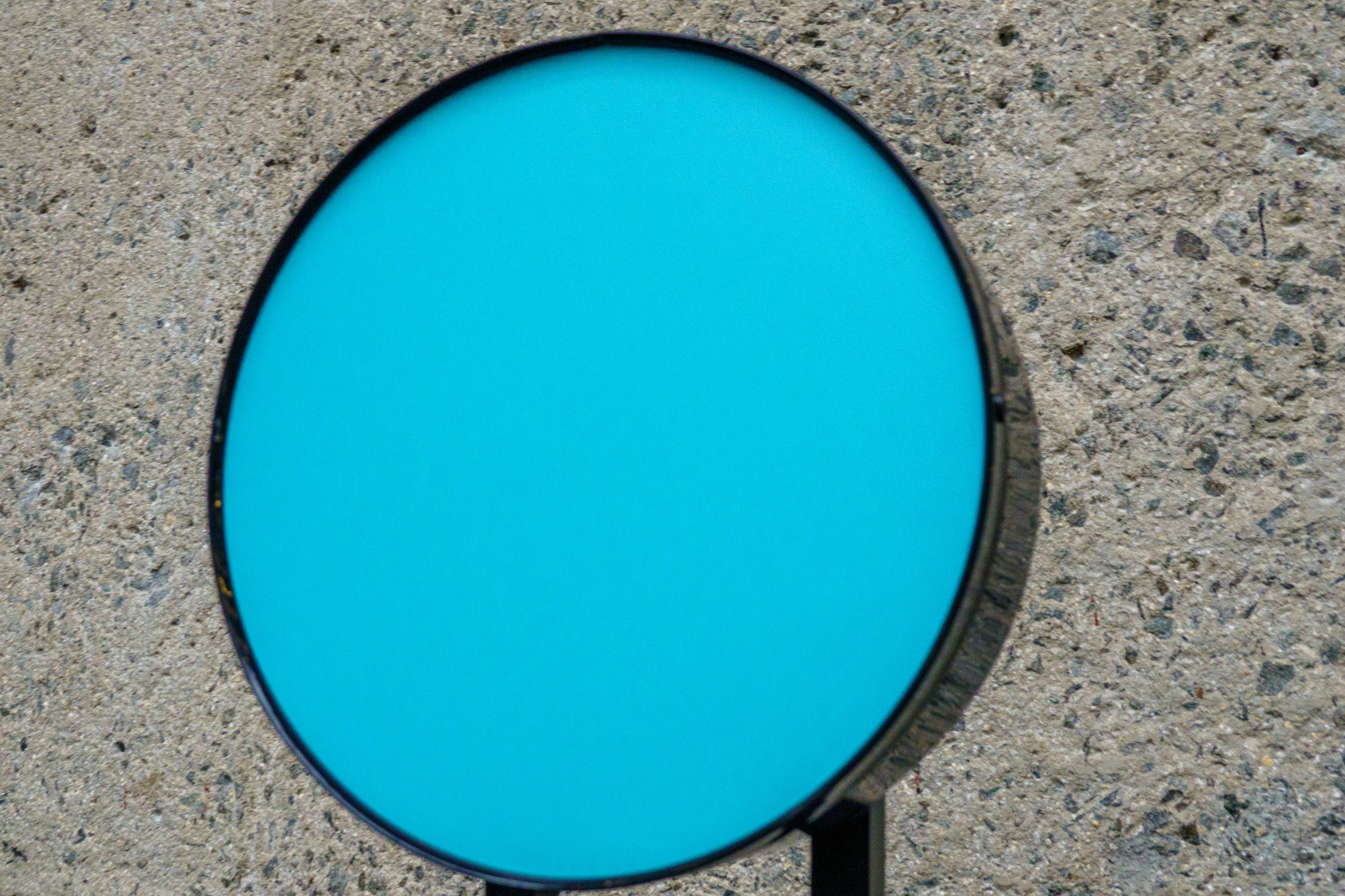 A blue round object on a black stand