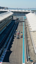 An aerial view of a race track with cars on it