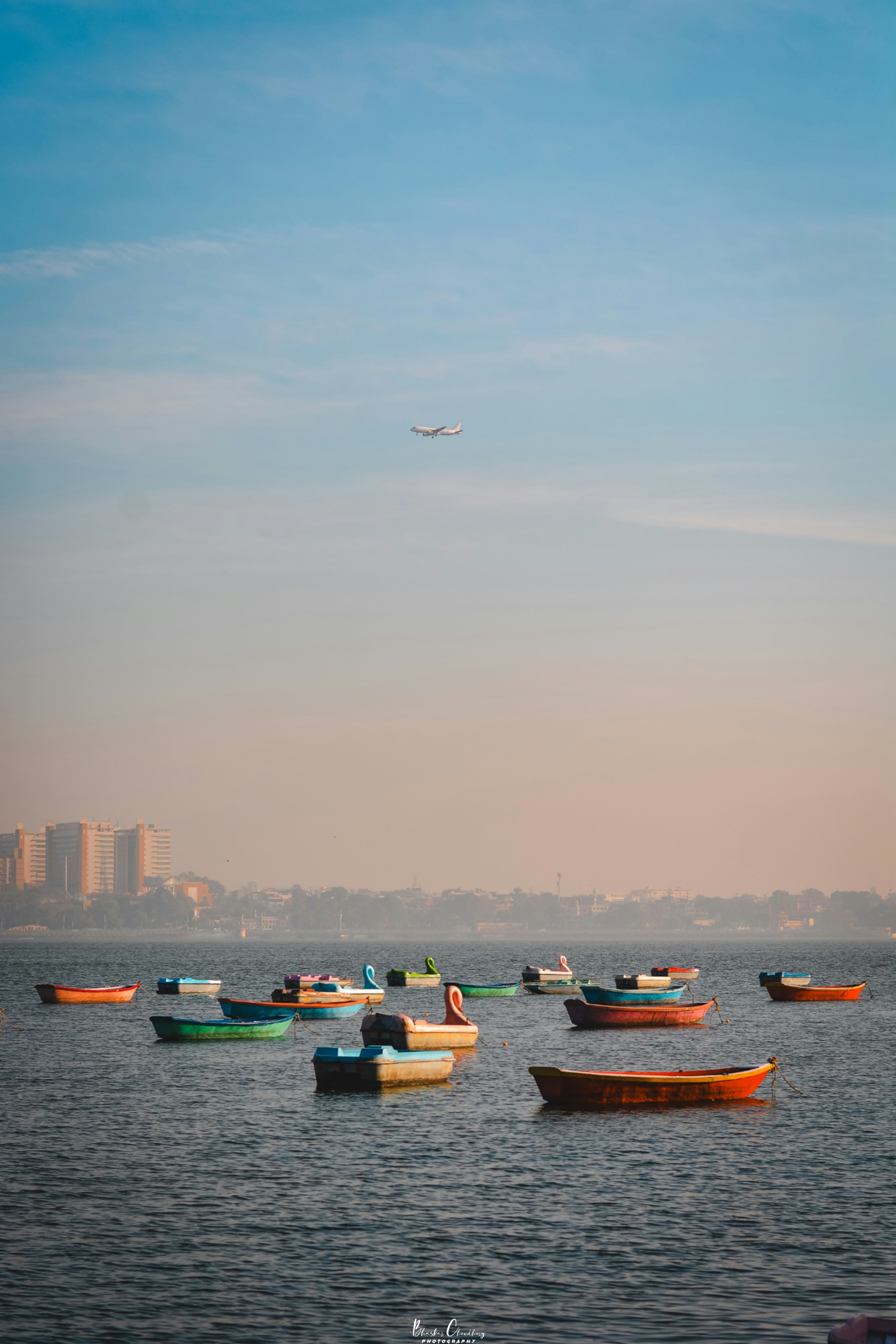 A group of boats floating on top of a large body of water