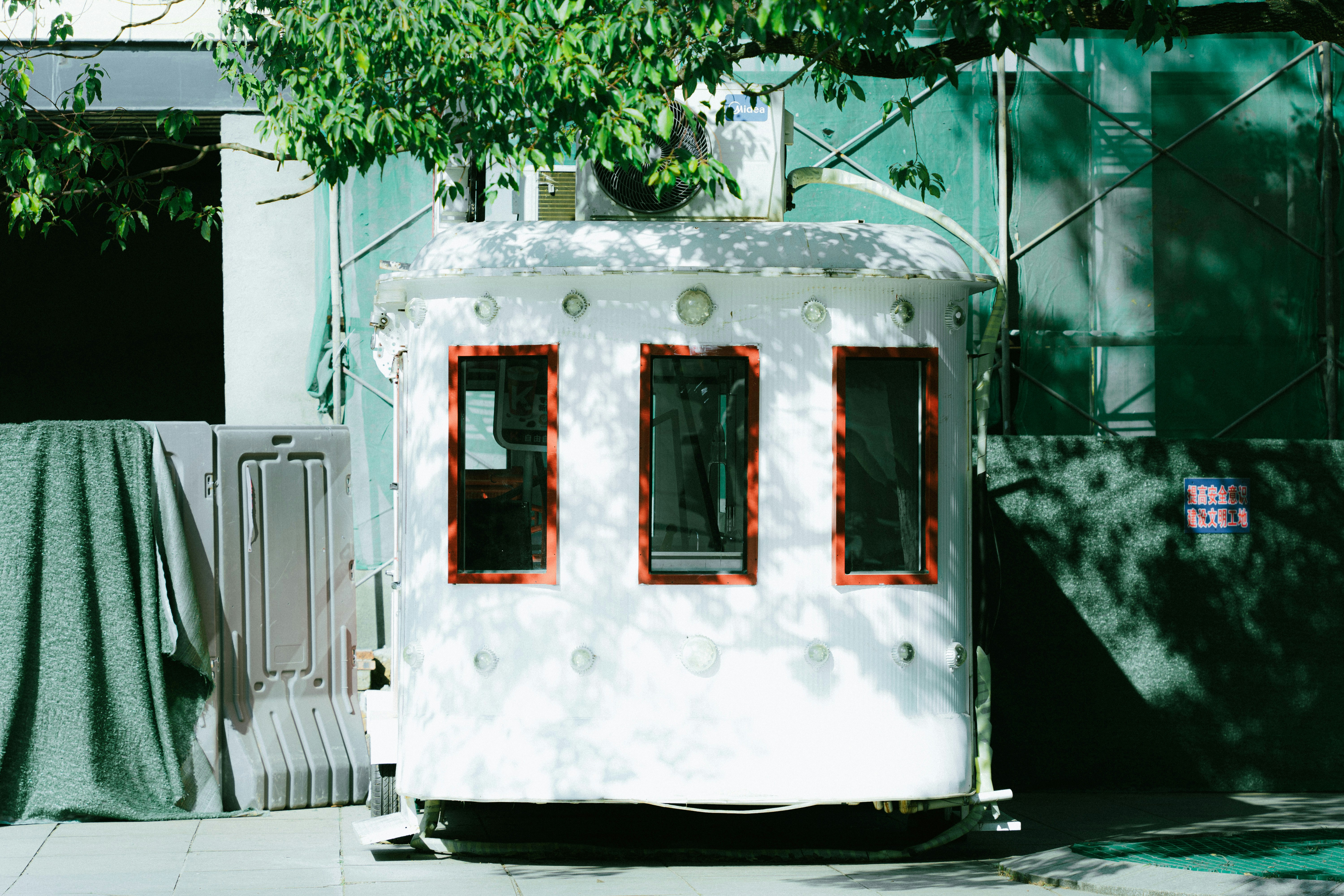 A small white house sitting on the side of a road