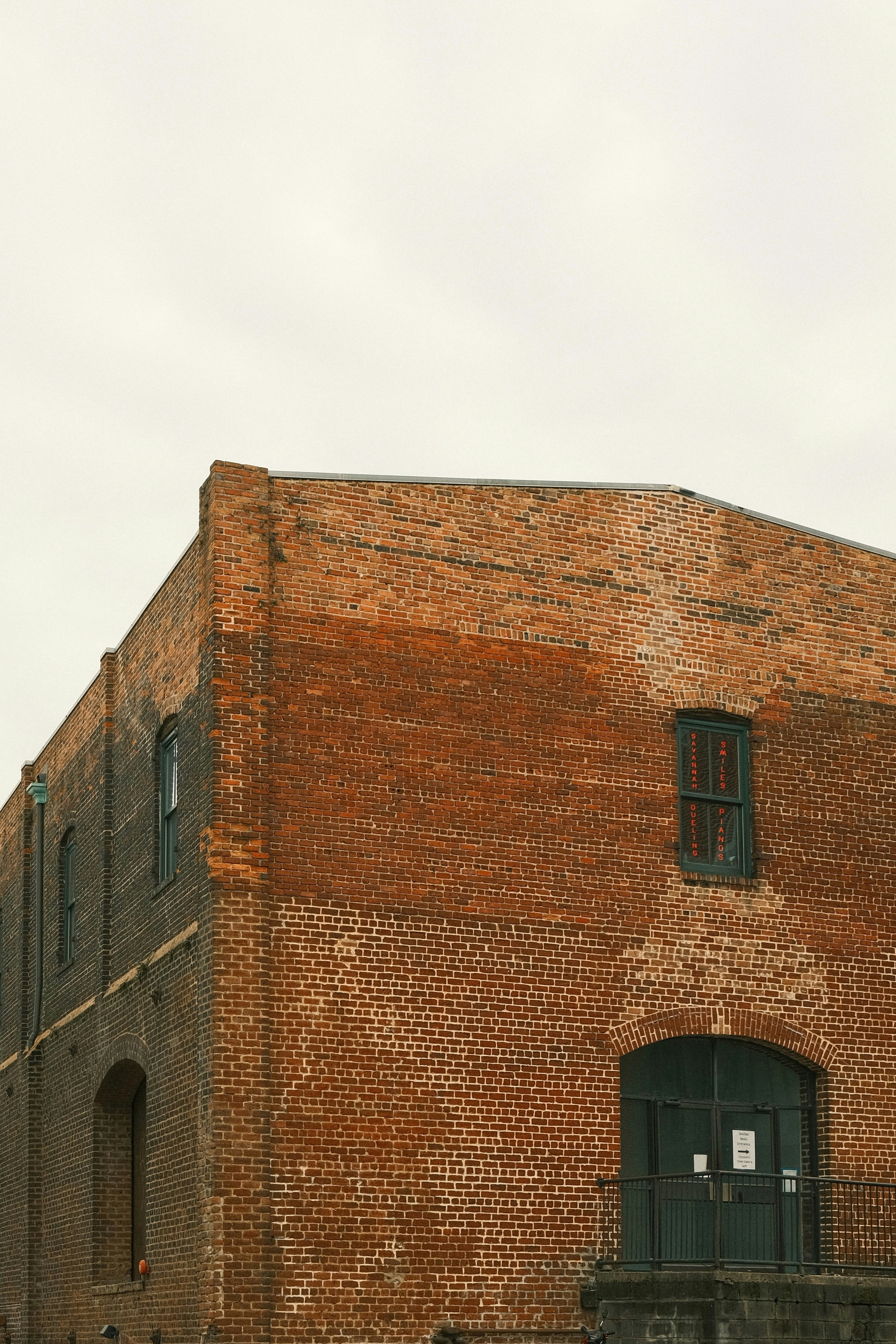 A brick building with a clock on the front of it