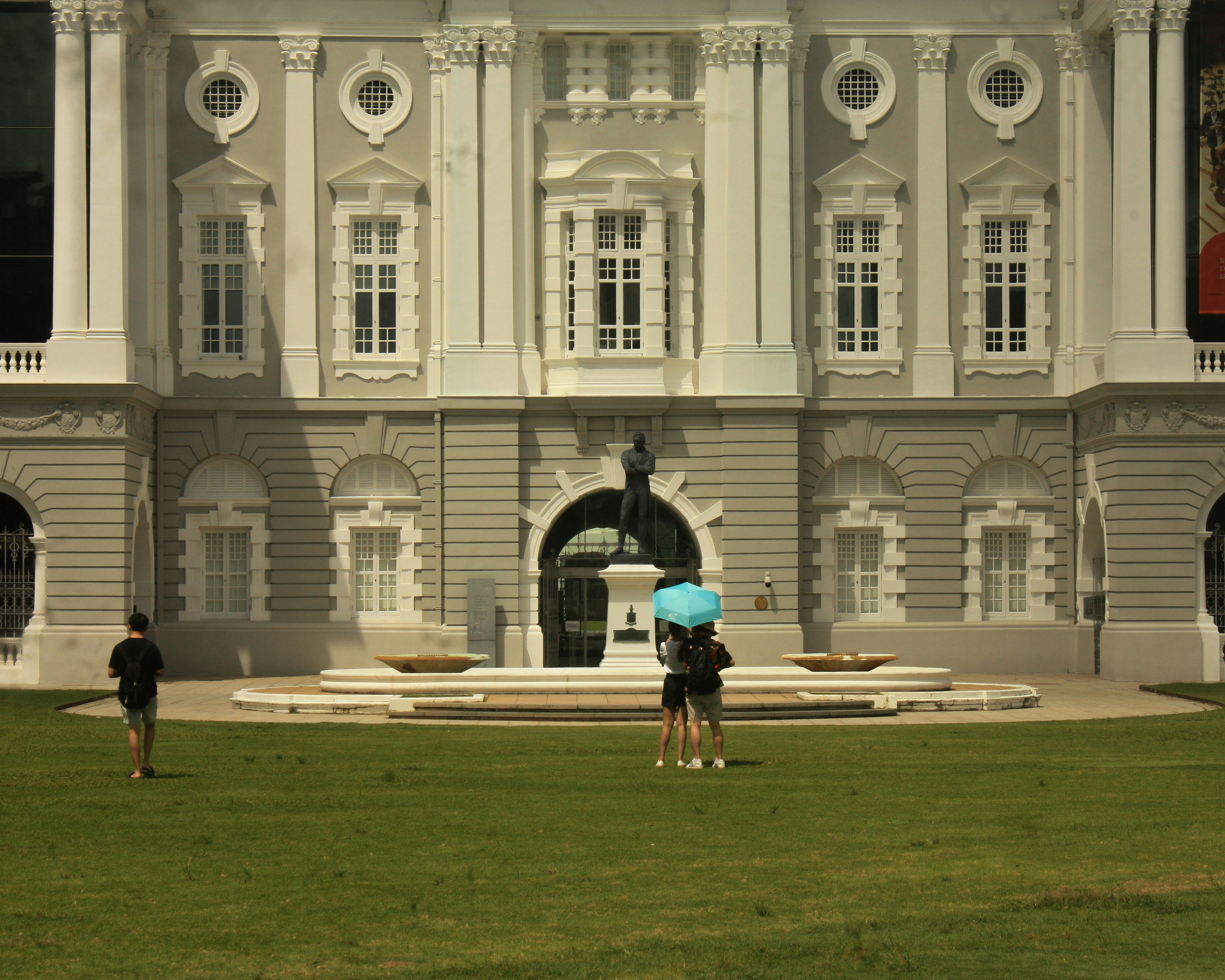 Two people standing in front of a large building
