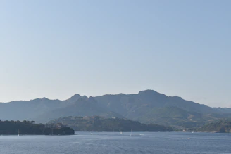 A large body of water with mountains in the background