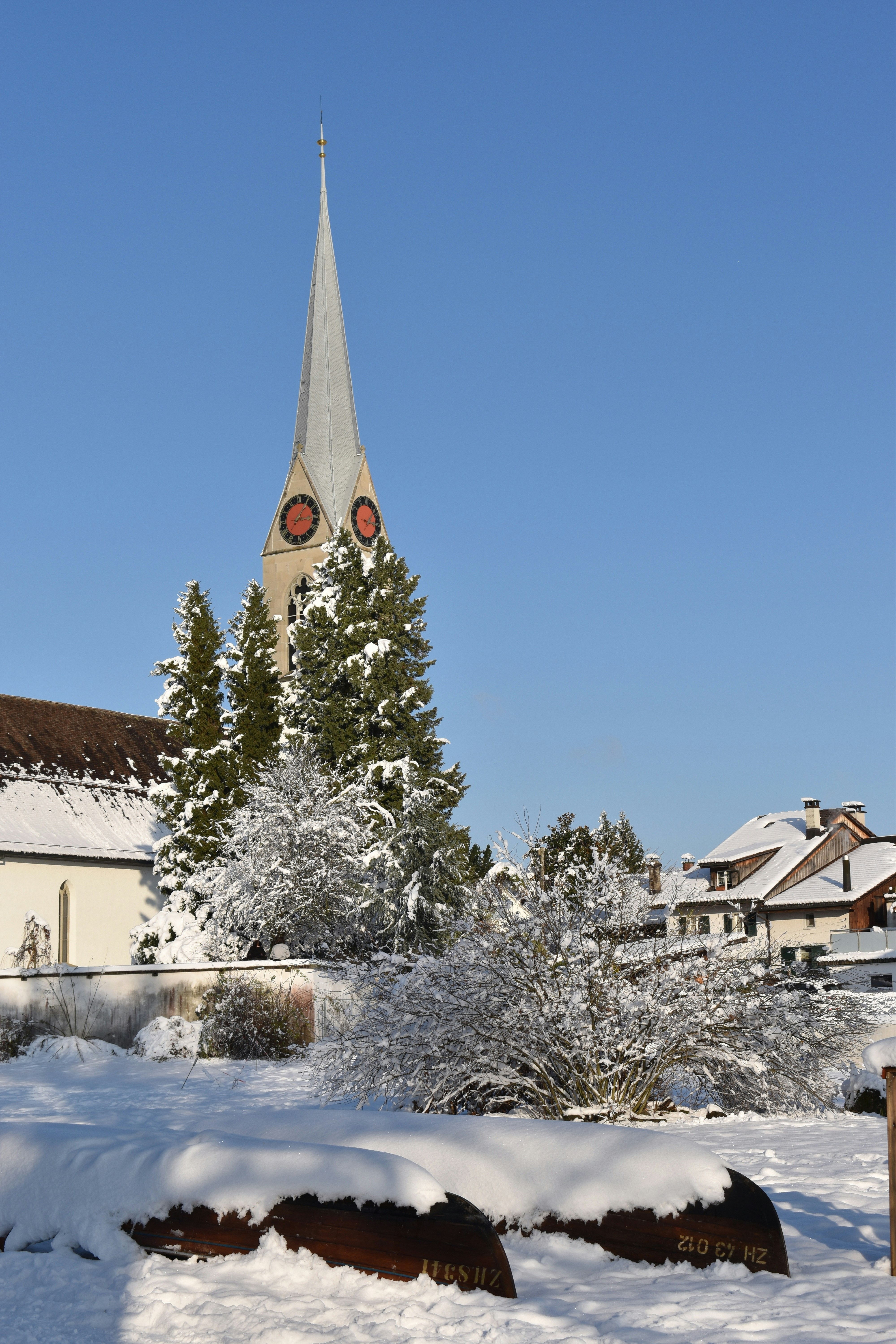 A church with a steeple covered in snow