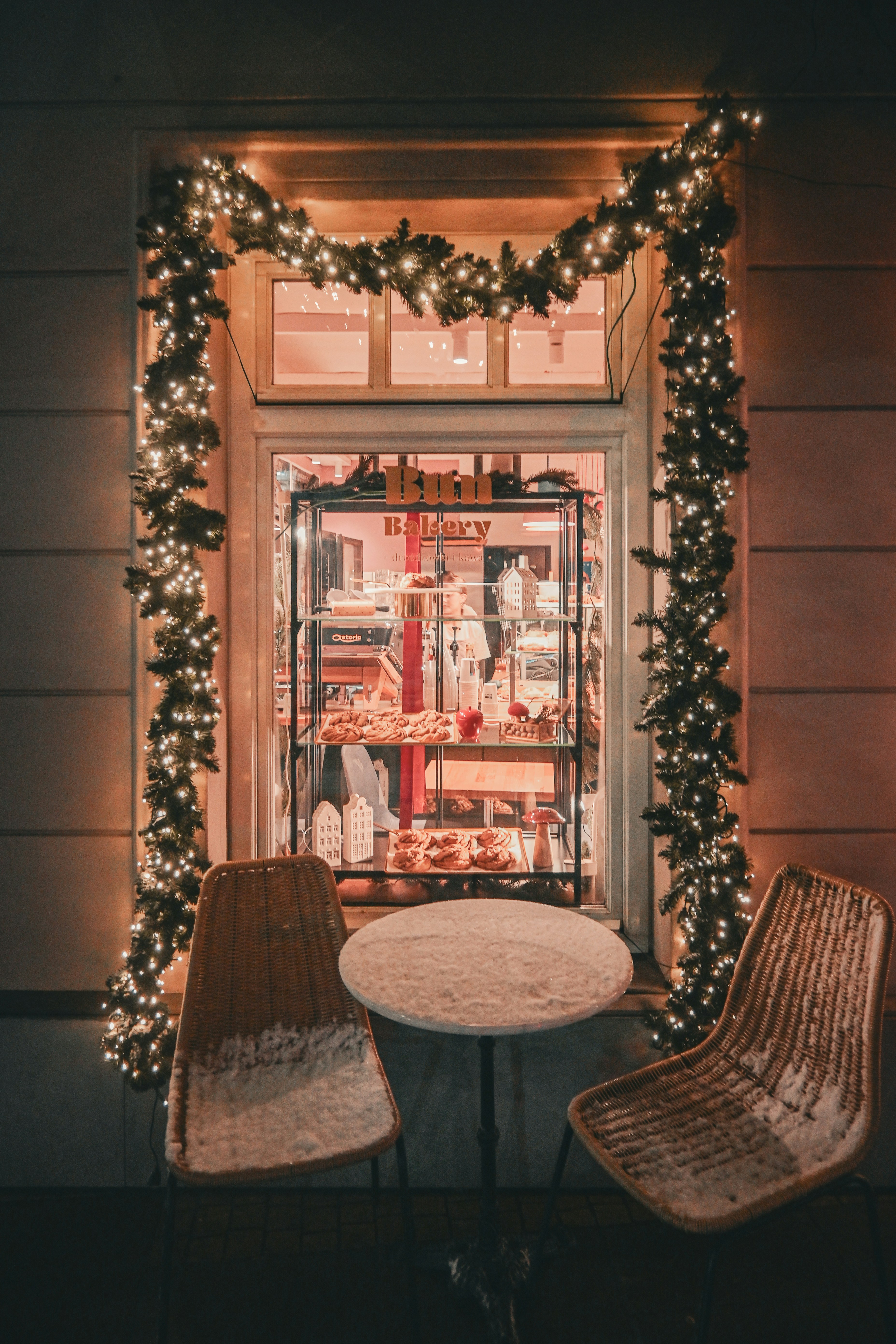 Two chairs and a table in front of a store