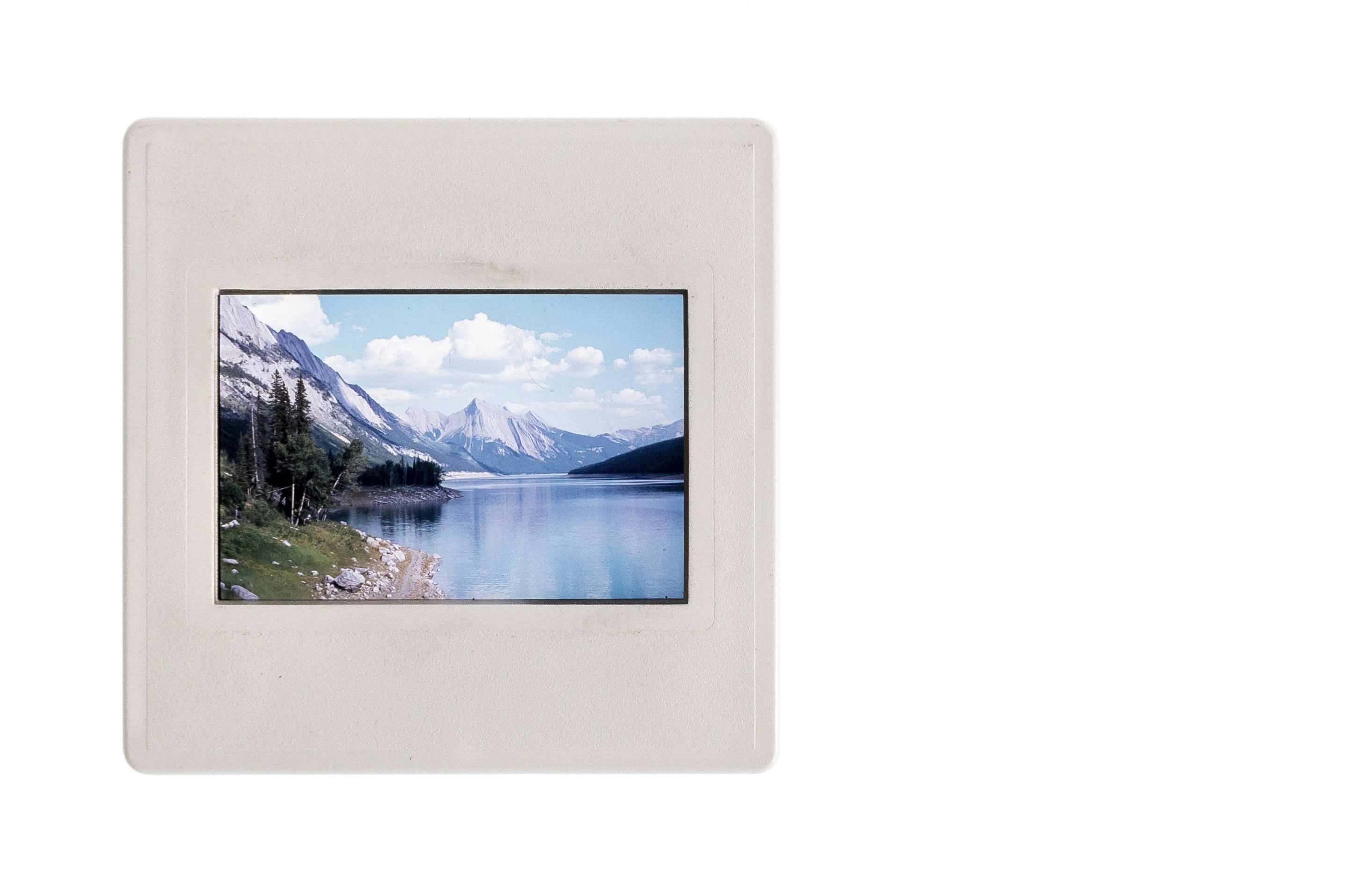 A picture frame with a lake and mountains in the background