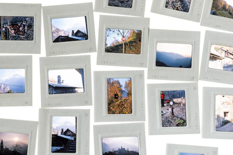 A wall covered edge to edge with polaroid photos pinned up in loose, overlapping rows
