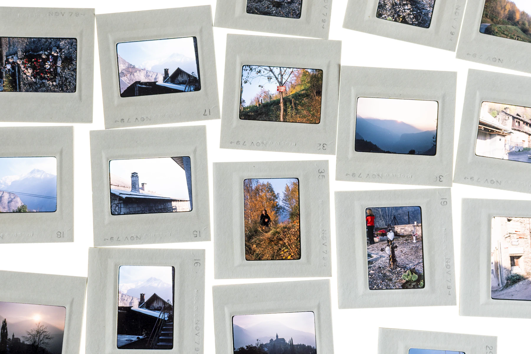 A wall covered edge to edge with polaroid photos pinned up in loose, overlapping rows
