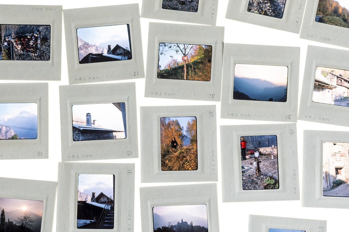 A scattered collection of old photo slides, each showing a different travel memory