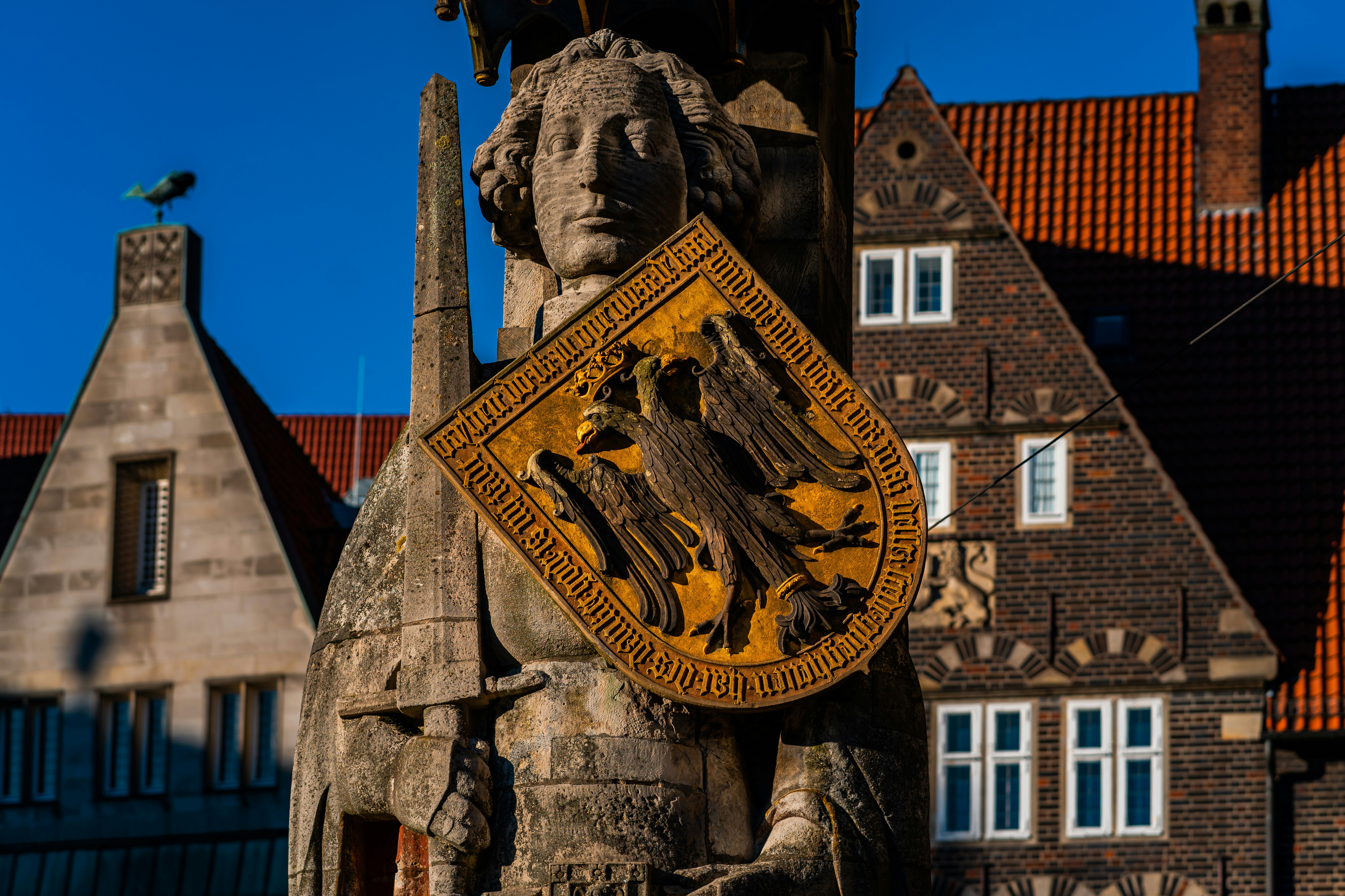 A statue of a woman holding a bird in front of a building