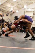 Two wrestlers in a wrestling match with a crowd watching