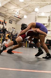 Two wrestlers in a wrestling match with a crowd watching