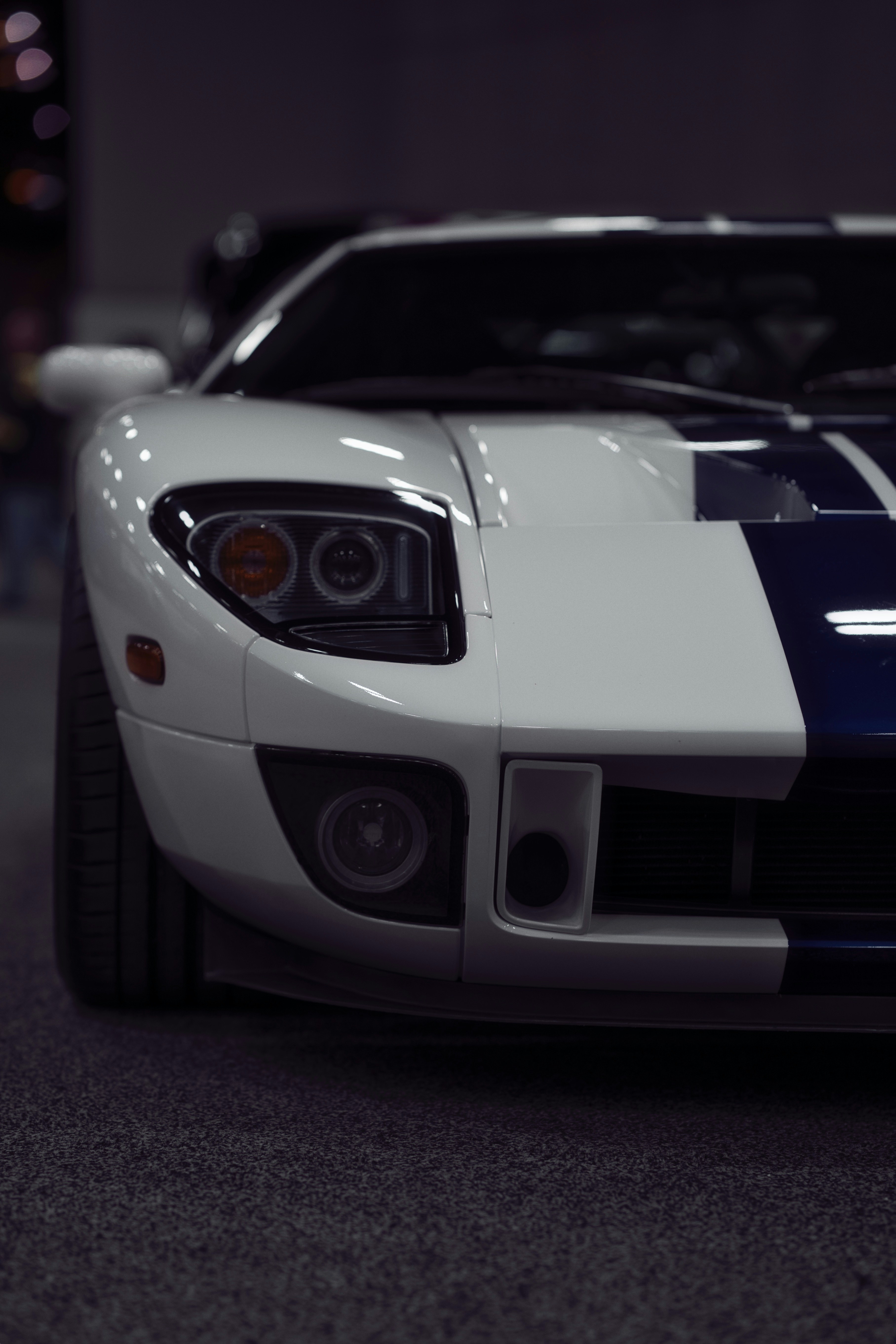 A white and blue sports car parked in a garage