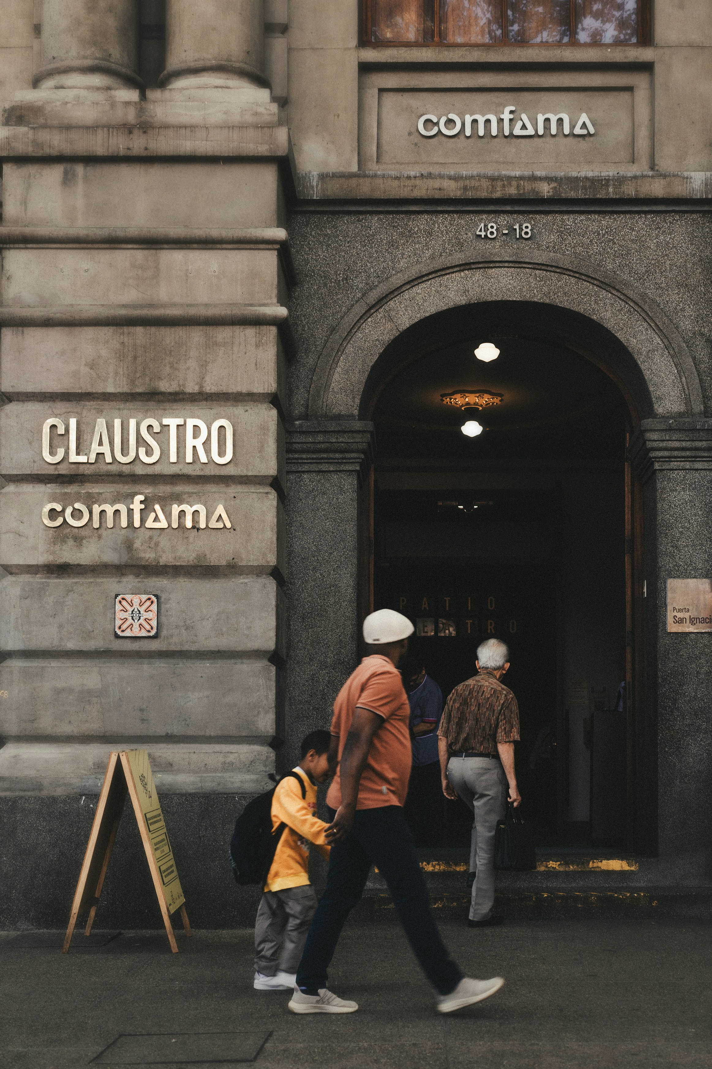 A group of people that are walking in front of a building photo – Free ...