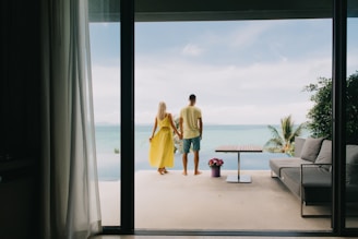 A man and a woman walking out of an open door