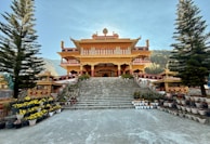 A large building with a lot of plants in front of it