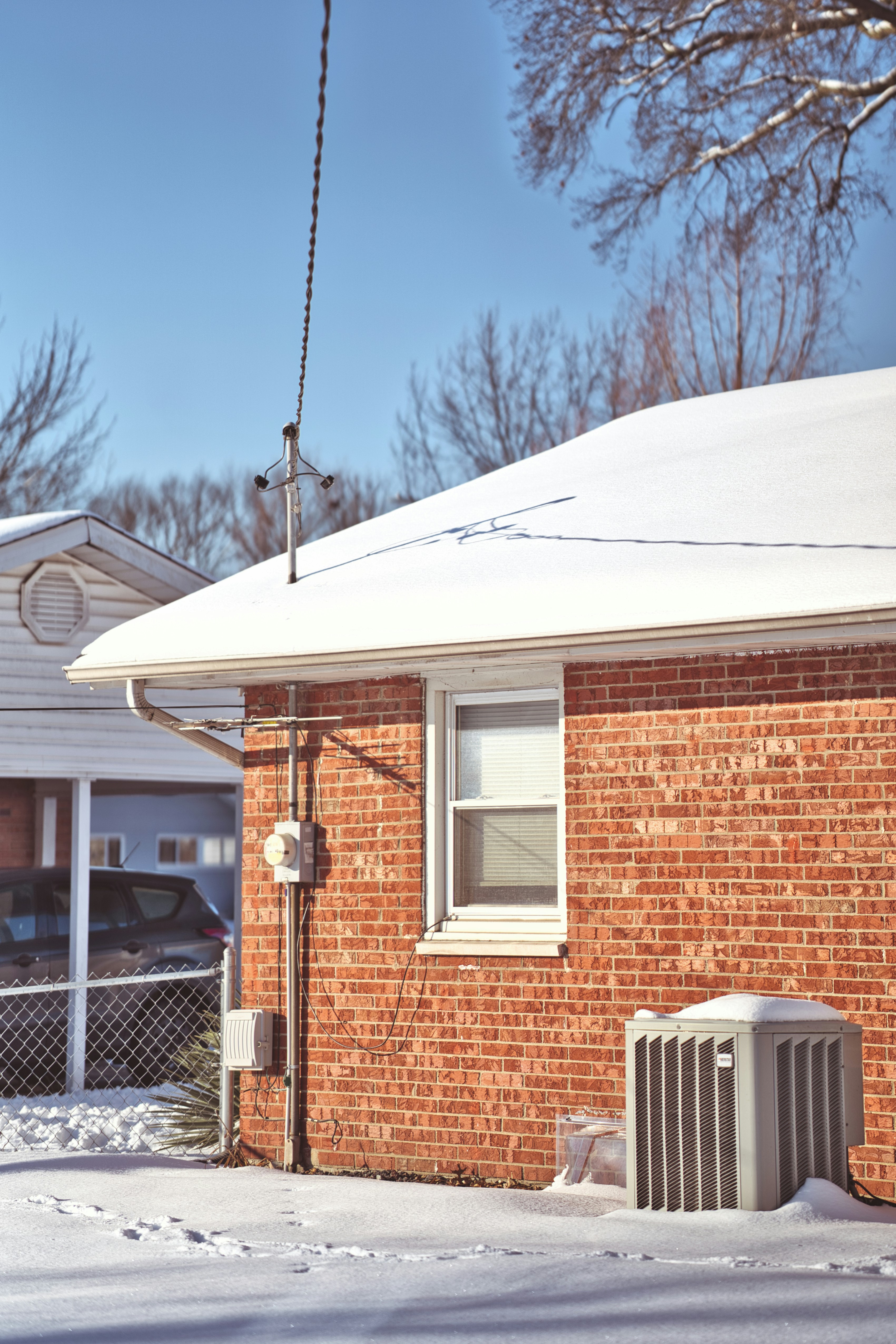 A red brick house covered in snow
