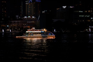 A boat floating on top of a body of water at night