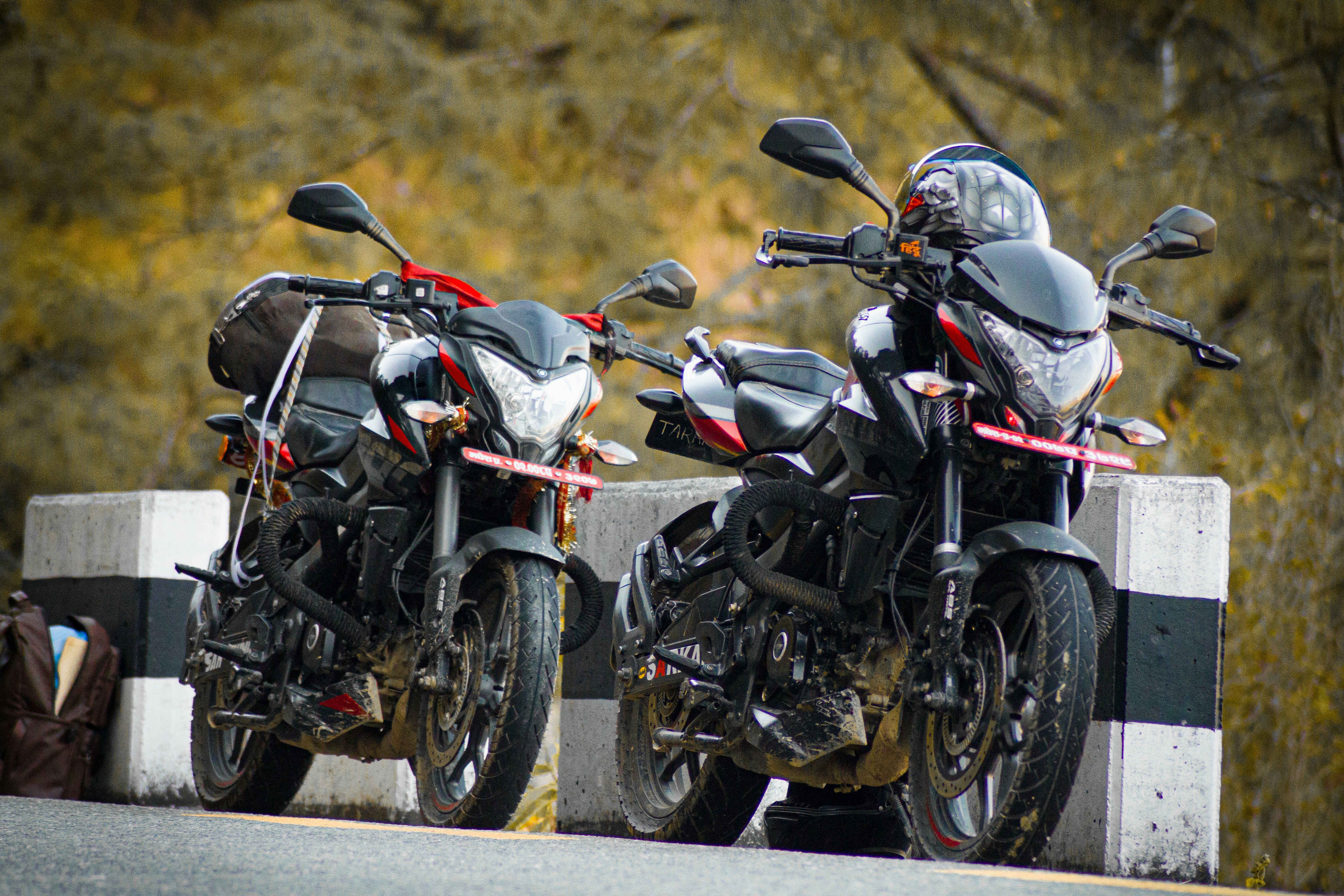 Two motorcycles parked next to each other on a road photo – Free ...